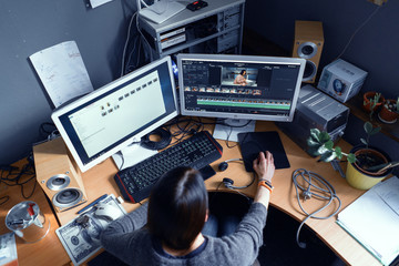 A Focused Woman Freelancer Works In A Video Editing Program