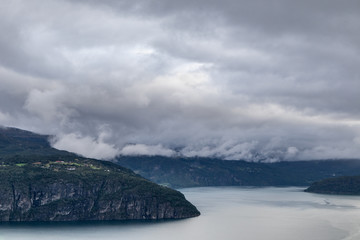Fototapeta na wymiar Cold grey color Norway landscape on fjord coast 
