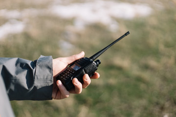 Close-up of a mans hand holding GMRS radio