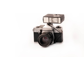 black with silver vintage manual analog mechanical camera with external flash and metal lens isolated on white