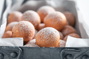 Homemade and yummy donut balls with powdered sugar