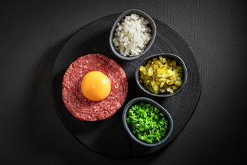 Enjoy your beef tartare with chives, gherkin and yolk
