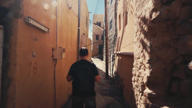 Young Man Visiting Abandoned Old Ruined Village of Al Hamra near Nizwa, Oman