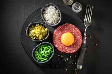 Raw beef tartare with chives, gherkin and yolk