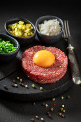 Delicious beef tartare with chives, gherkin and yolk