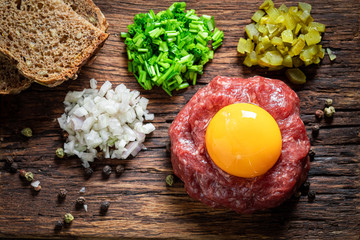 Enjoy your beef tartare with onion, cucumber and chives