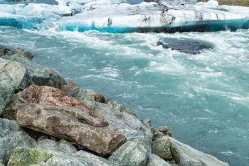 Icebergs floating in the cold water of the Jokulsarlon glacial lagoon. Vatnajokull National Park, in the southeast Iceland during a road trip