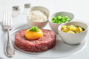 Raw beef tartare with yolks, chives and pepper