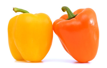 ripe yellow and orange peppers isolated on white background
