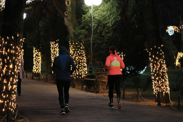 People running at night in Cismigiu Park, Bucharest, Romania, 2020