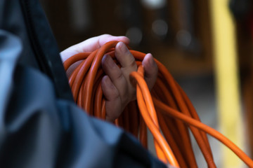 orange extention cord ready to use to plug in electric items - obrazy, fototapety, plakaty