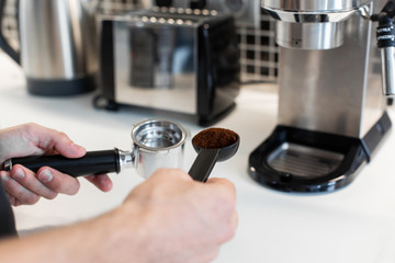 Guy prepare delicious aromatic coffee in a coffee machine. A simple way to make coffee