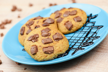 Sweet chocolate chip cookies on blue plate
