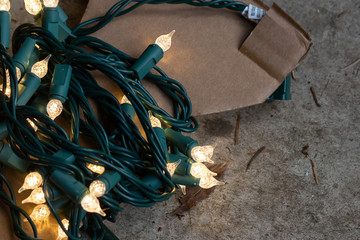 strings of christmas lights hanging down ready to decorate a home
