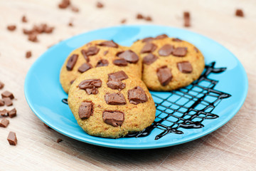 Sweet chocolate chip cookies on blue plate