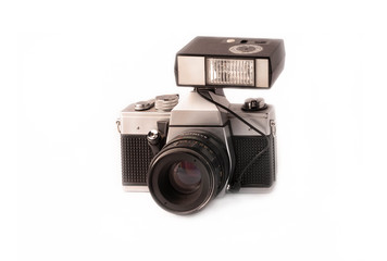 black retro old manual camera with external flash and lens isolated on white