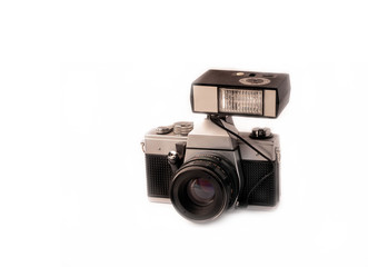 black vintage old manual camera with external flash isolated on white