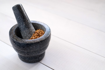 cilantro coriander seeds with granite mortar