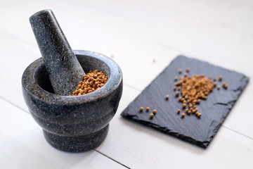 cilantro coriander seeds with granite mortar