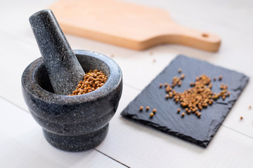 cilantro coriander seeds with granite mortar