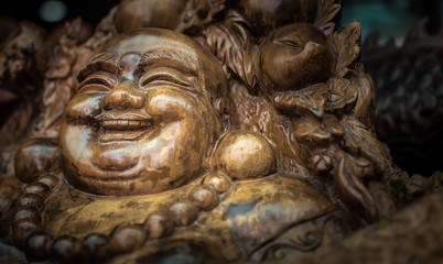 Smiling Buddha. Decorative woodwork made for the armchair.