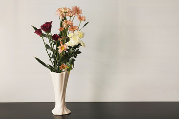Fototapeta na wymiar Fresh various flowers in vase on white background