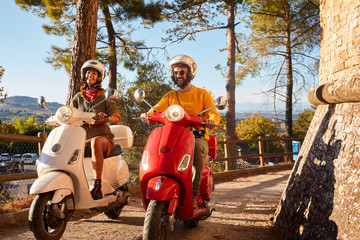 Happy man and girl  riding a scooter and having fun.