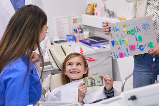 Tooth Fairy Rewarding Little Girl