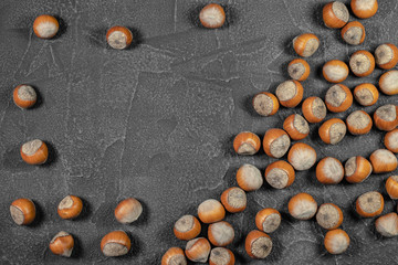 Hazelnut scattered on a black background. Full frame