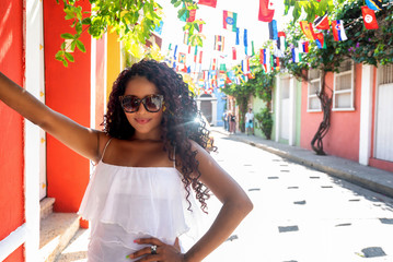 Beautiful local Colombian woman in white dress in the walled city of Cartagena, Colombia