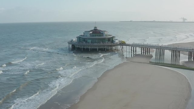 Coastine construction pier Aerial view shot sand and sea belgium