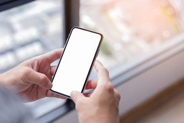 Mockup image blank white screen cell phone.woman hand holding texting using mobile.background empty space for advertise text.people contact marketing business,technology 