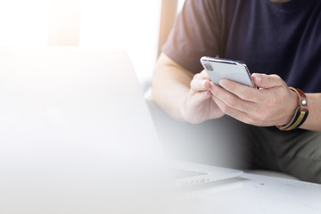 hand holding using texting cell phone and typing computer.people Thinking investment plan.chatting contact Investor.searching for information use internet.connecting people concept