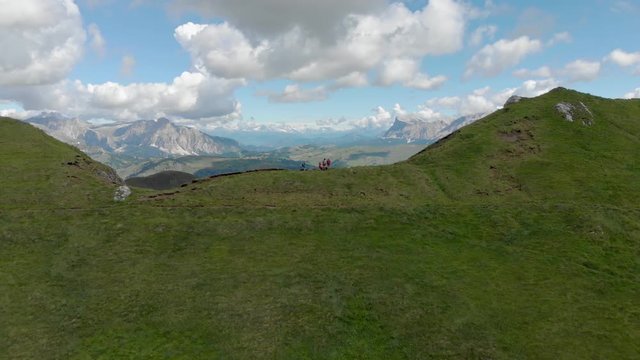 Mountain ridge with family standing and watching beautiful landscape in Dolomites, Italy 4k