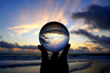 Beautiful clouds during sunrise captured through a lens ball at Fort Lauderdale Beach, Florida,...