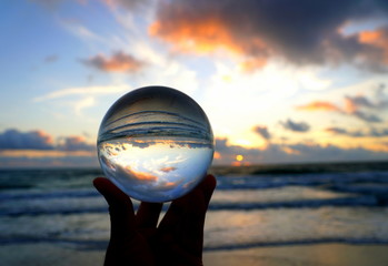 Beautiful clouds during sunrise captured through a lens ball at Fort Lauderdale Beach, Florida,...