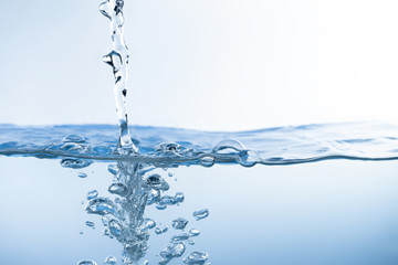 Water splash. Aqua flowing in waves and creating bubbles. Drops on the water surface feel fresh and...