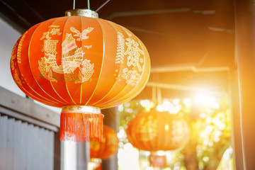 Closeup beautiful Chinese decoration red lanterns hang on ancient shrine ceiling with blurry and...