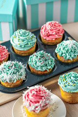 Homemade cupcakes with pink and blue icing decoration