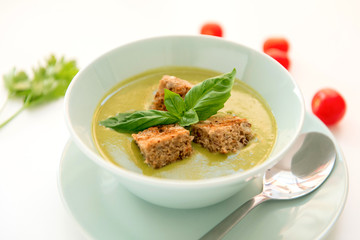 Pea cream soup on the dinner table