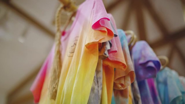 El Nido, Philippines - Vibrant Colored Dyed Shirts Hanged And Air Dried On A Wooden Clothesline - Close Up Shot
