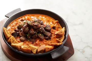 Beef steak with tomato sauce and bread 