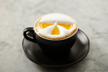 Cafe latte, latte art with orange 
