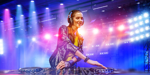 Female dj in nightclub. Mixed media