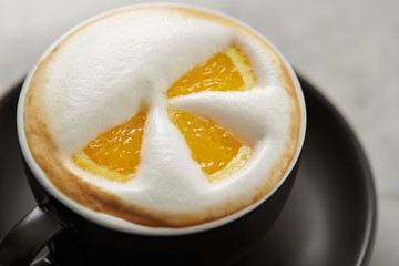 Cafe latte, latte art with orange 