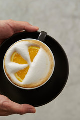 Cafe latte, latte art with orange 