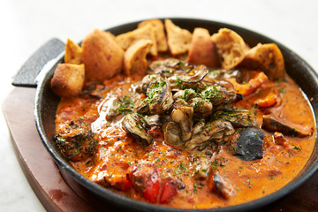 Grilled oyster with tomato sauce 