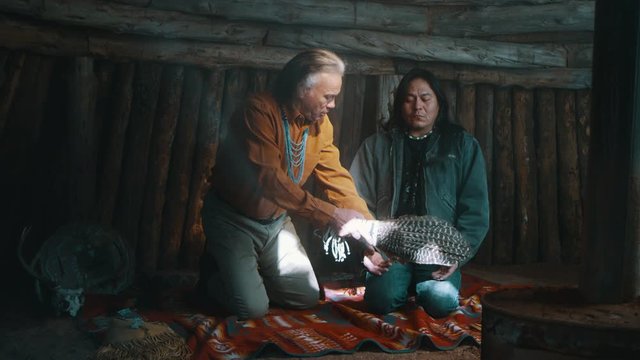 Native American Men Performing Prayer Meditation Blessing Ritual with Sage