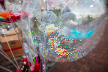 A transparent balloon with confetti inside