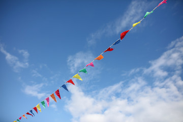 Multi-colored flags on a background of blue sky